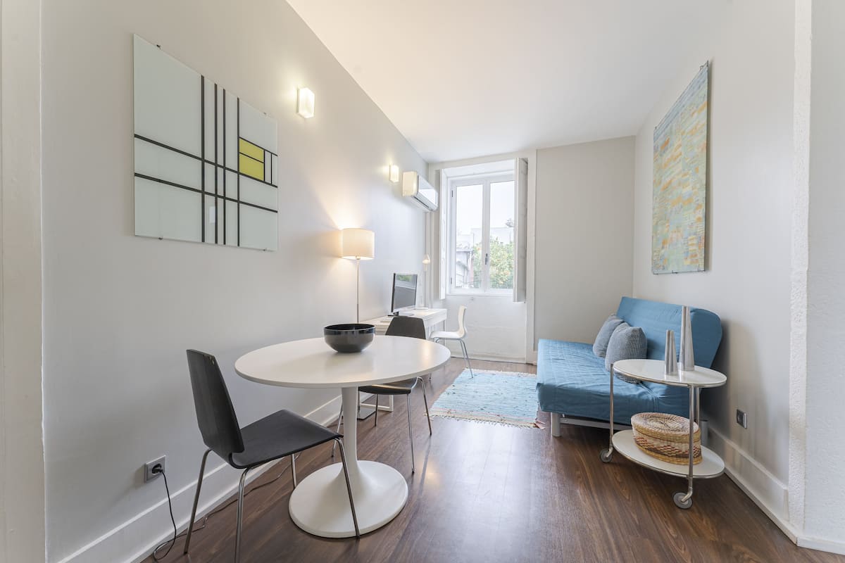 A modern living room with a dining area, a sofa, and a coffee table.
