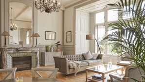 A spacious living room with a fireplace, a sofa, a coffee table, and a dining area. - Château Les Carrasses (Quarante)