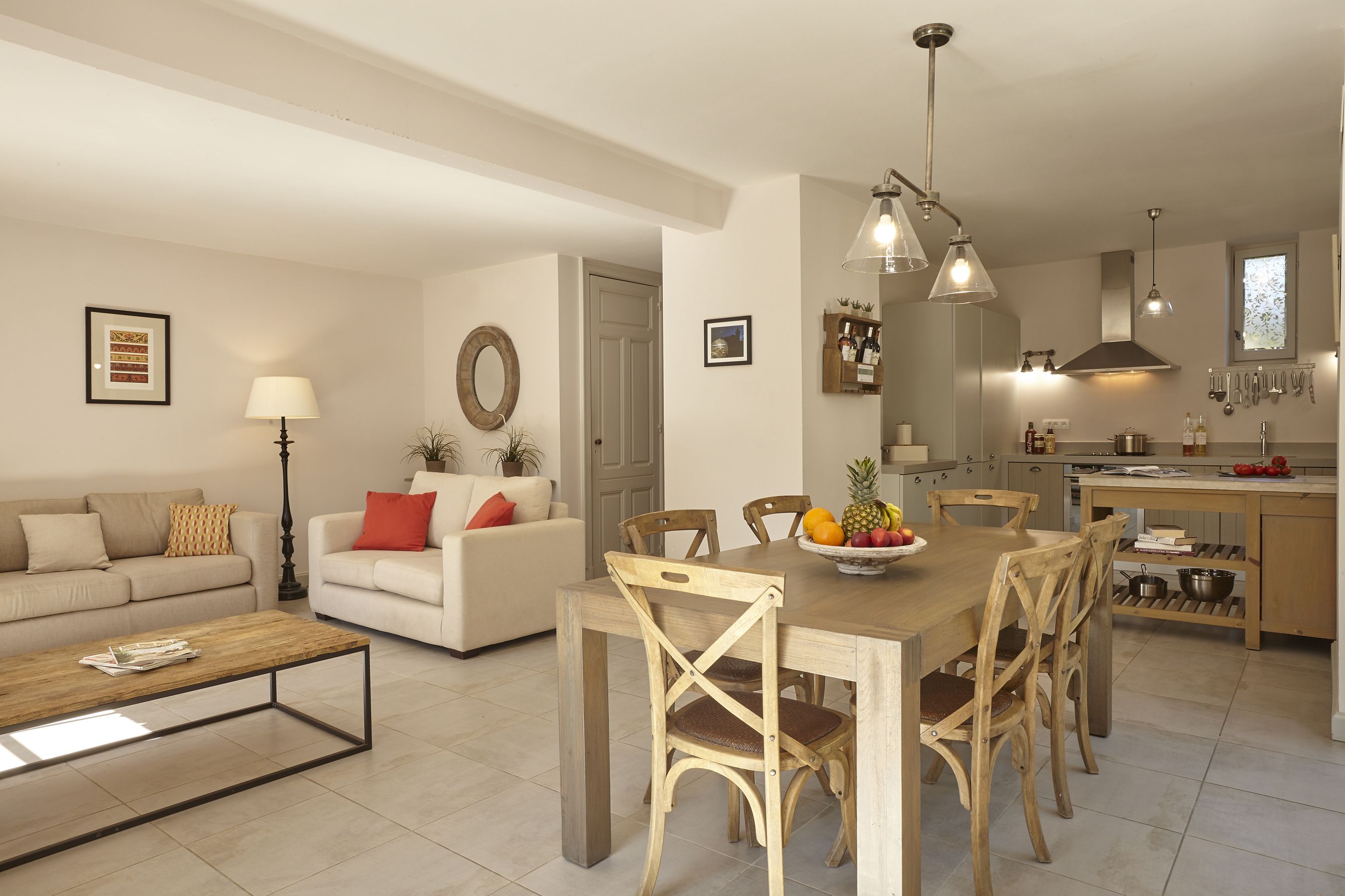 A modern living room with a sofa, coffee table, and dining area.
