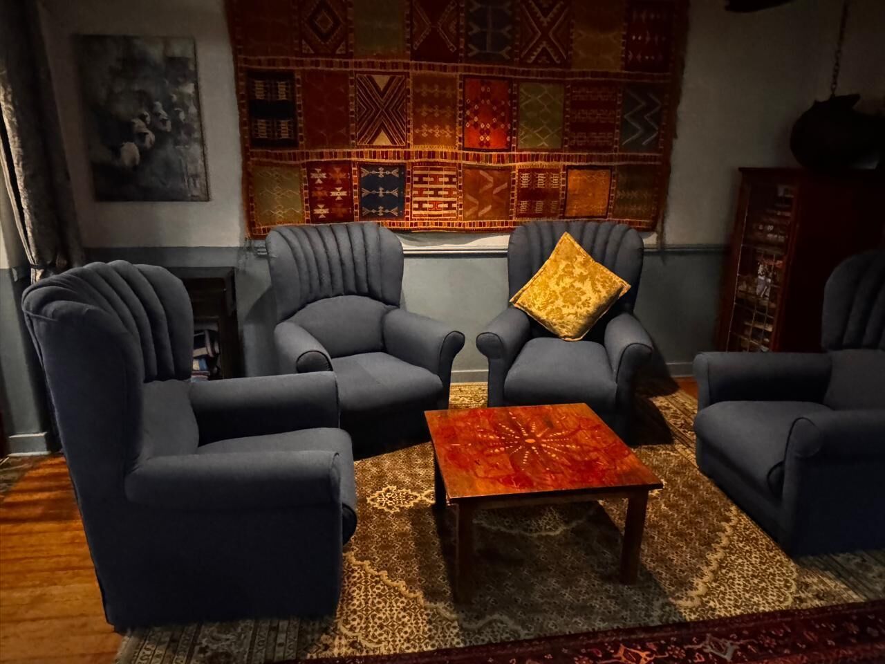 A living room with a sofa set, a coffee table, and a patterned rug.