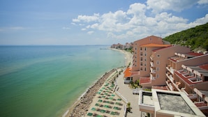 A coastal hotel with a beach view, multiple balconies, and a clear sky. - Royal Bay Hotel – All Inclusive (Elenite)