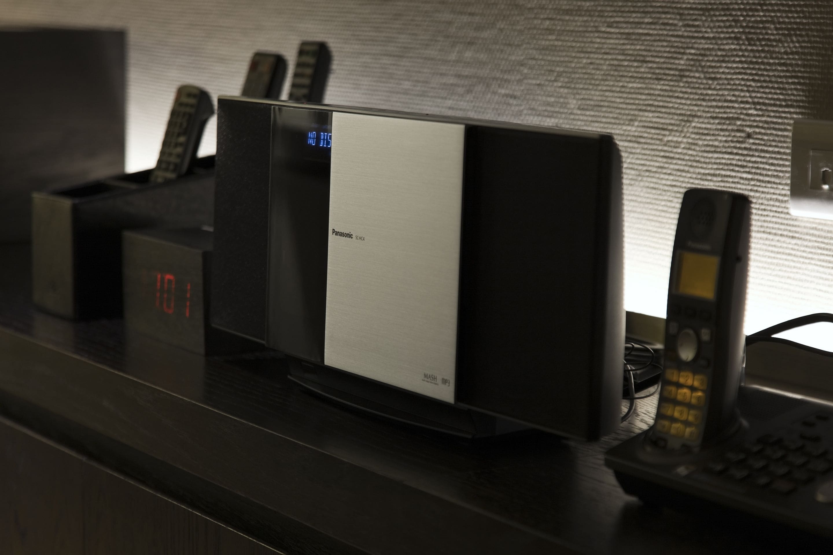 En Panasonic mikrobølgeovn på en mørk bordplade med et digitalt ur der viser 10:01.