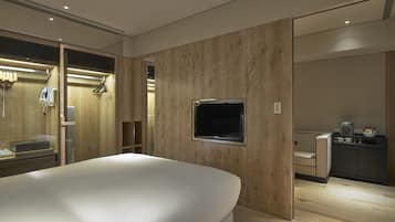 Relax in a spacious room with a large bed, flat-screen TV, and desk with a coffee maker.