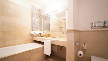 A modern bathroom with a bathtub, toilet, and sink.