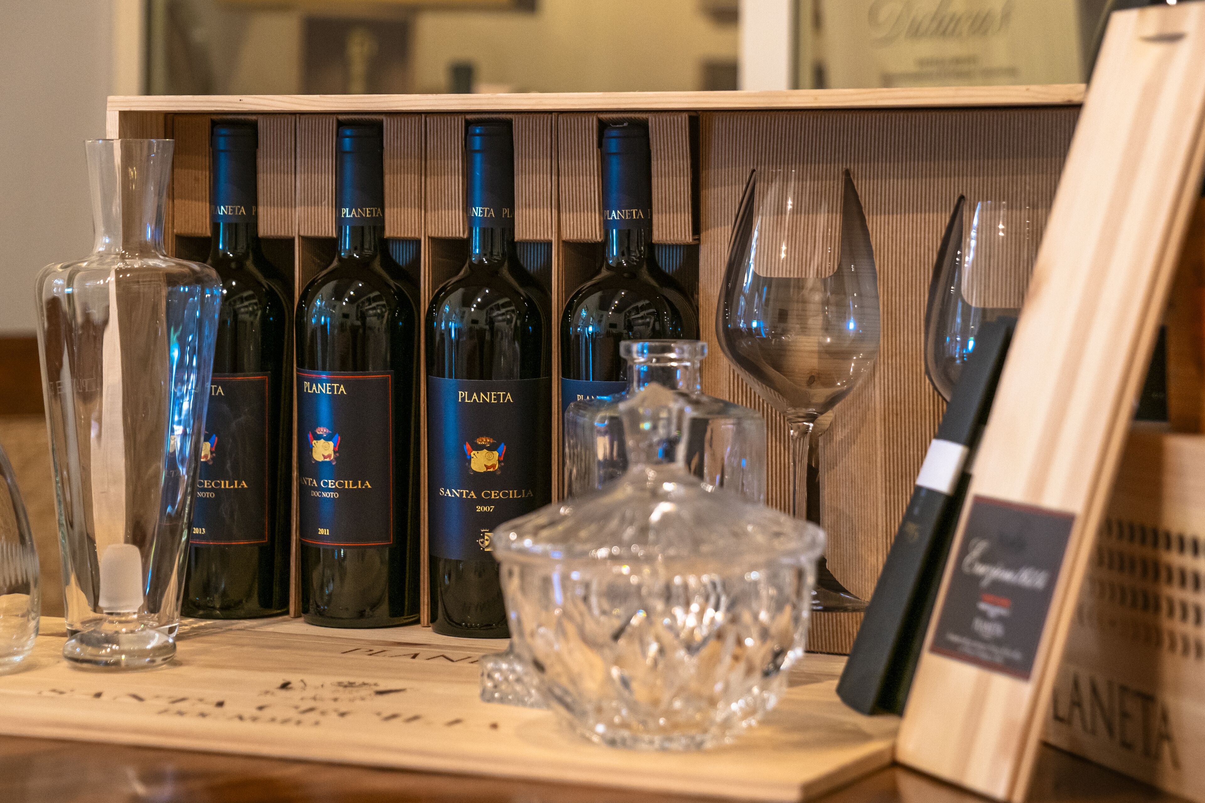 A wooden wine display with bottles and glasses.
