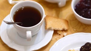 A breakfast setting with a cup of coffee, toast, jam, and a glass of orange juice on a table. - Hotel Al Malcanton (Venice)