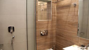 A modern bathroom with a shower, a sink, and a mirror.