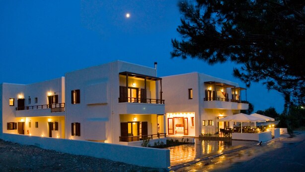 A modern multi-story hotel with balconies, a pool area, and outdoor seating. - Syia Hotel (Kantanos-Selino)