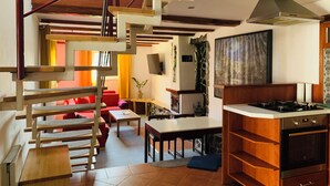 A modern kitchen with a gas stove, a built-in oven, and a stainless steel range hood. - Pension Aqualand (Poprad)