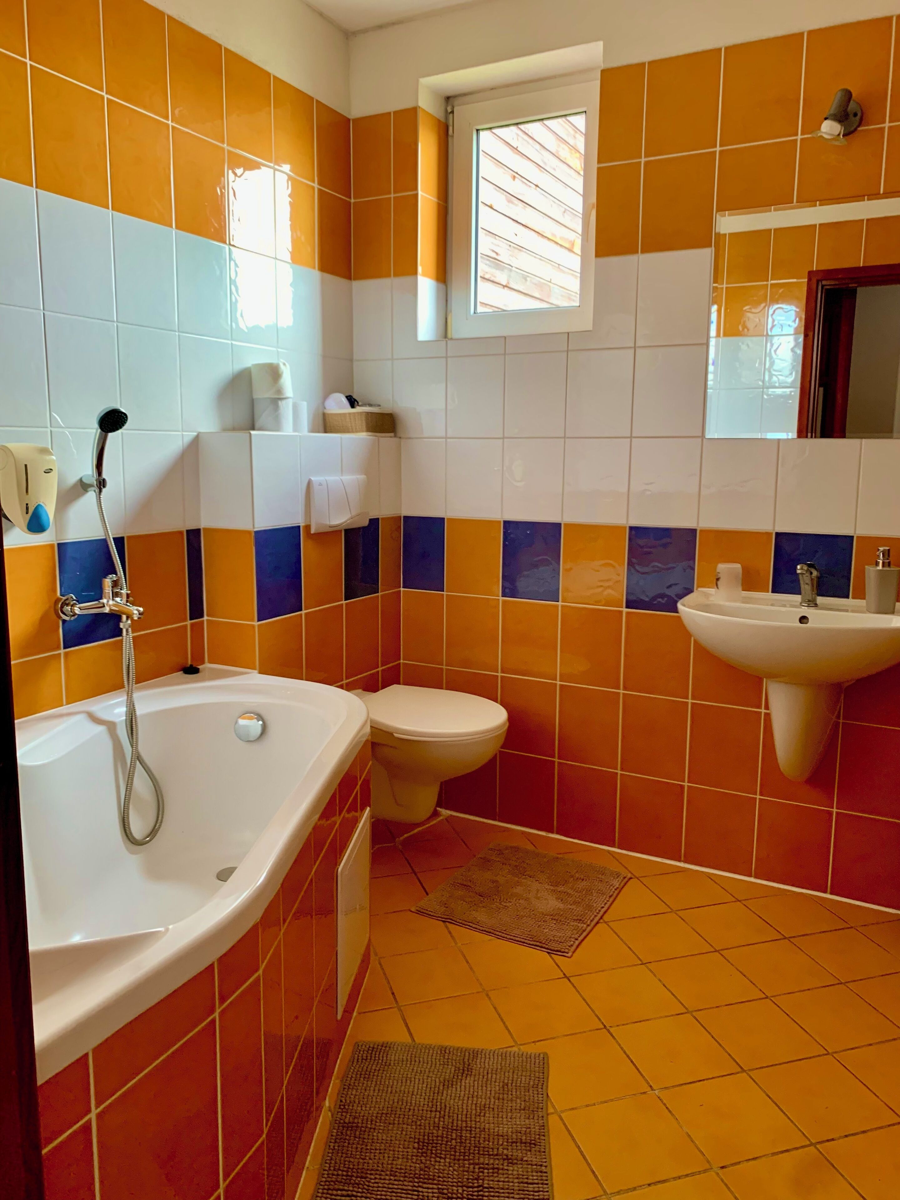 A bathroom with a bathtub, toilet, and sink.