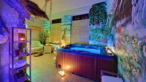 A spa room with a hot tub, a wooden cabinet, a cushioned chair, and a wall mural. - Rezydencja Bialy Jar (Karpacz)