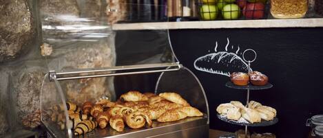 A bakery display with pastries and a chalkboard menu.