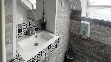 Desk, iron/ironing board, bed sheets