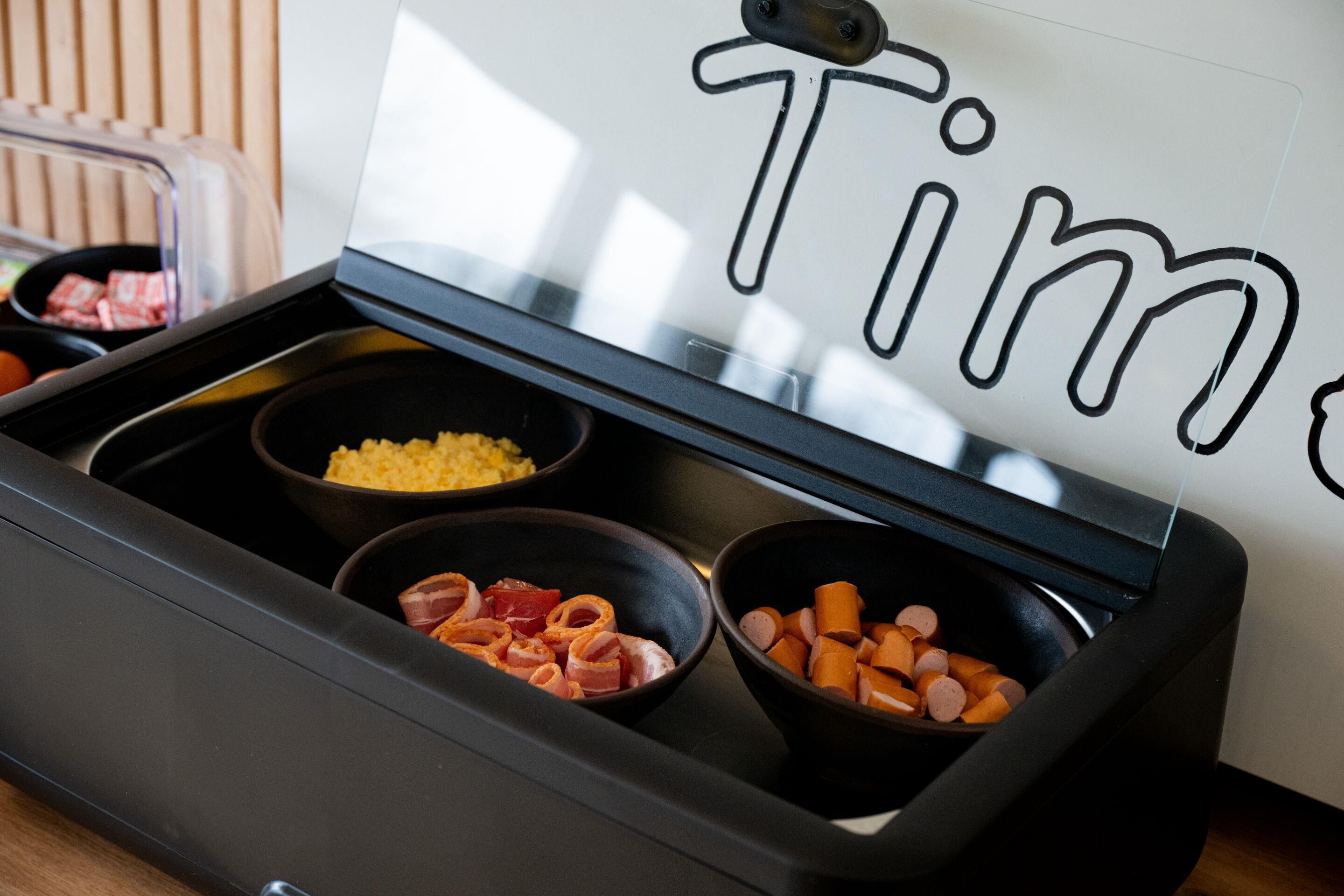 A kitchen counter with three bowls containing different food items.