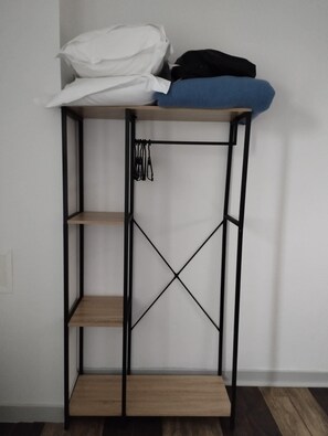 Desk, iron/ironing board, bed sheets