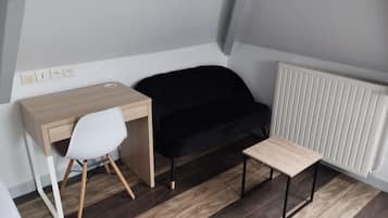 Desk, iron/ironing board, bed sheets