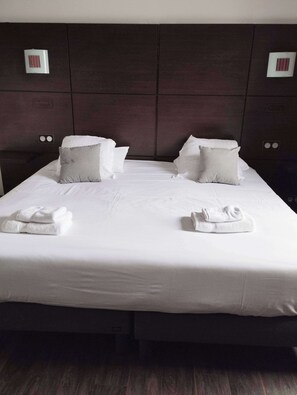 Desk, iron/ironing board, bed sheets