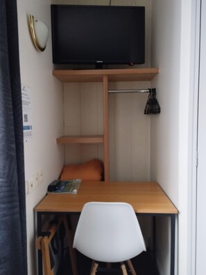 Desk, iron/ironing board, bed sheets