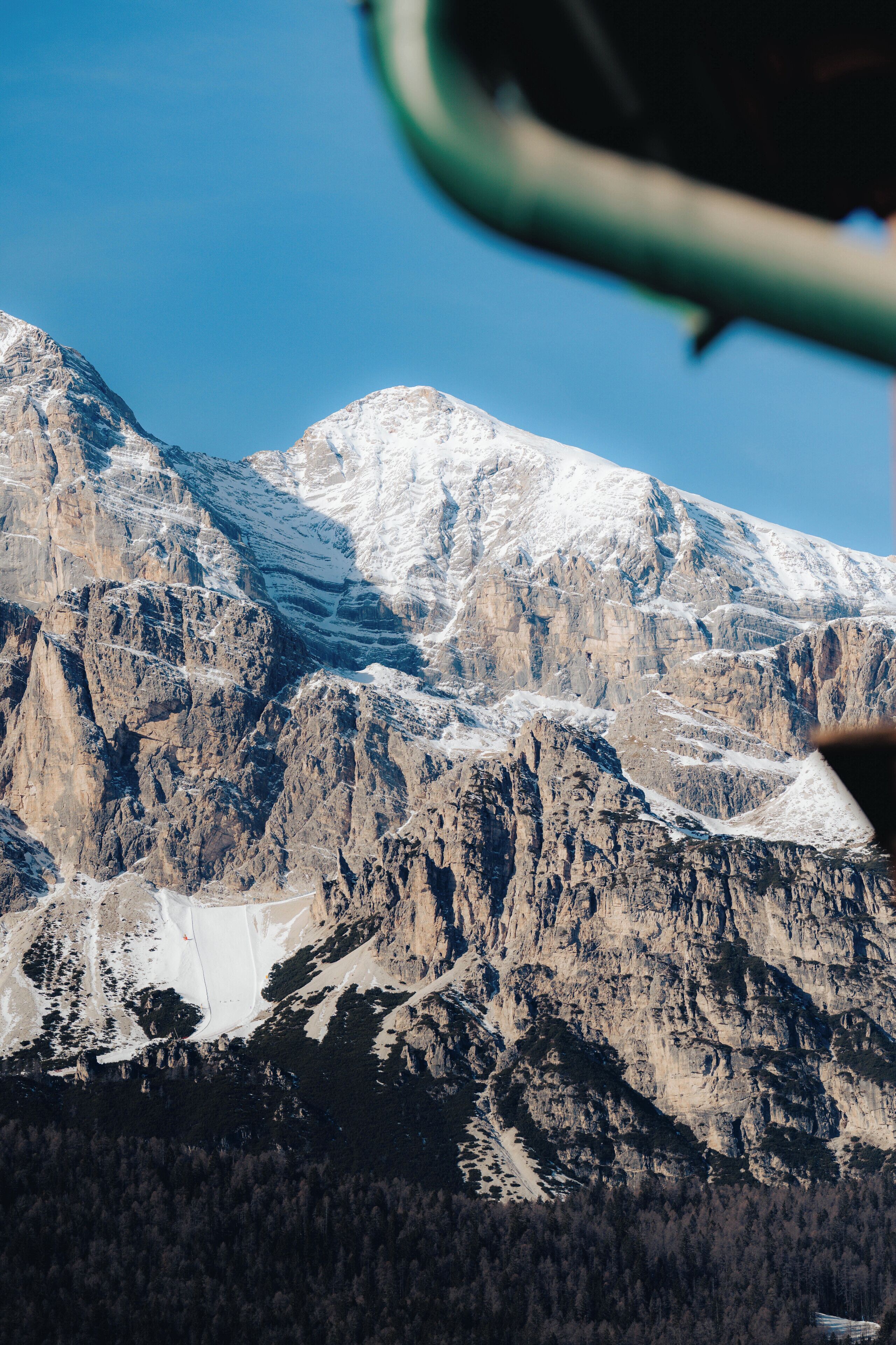 A mountainous landscape with rocky terrain and snow-covered peaks.