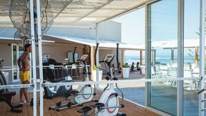 A gym with exercise equipment and a view of the ocean. - Georgioupolis Beach Hotel (Apokoronas)