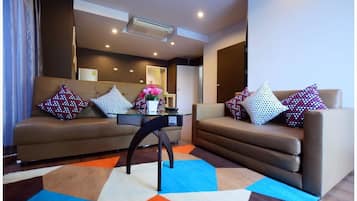 Family Twin Room, 2 Bedrooms, Poolside | Living room | 32-inch LCD TV with cable channels, TV