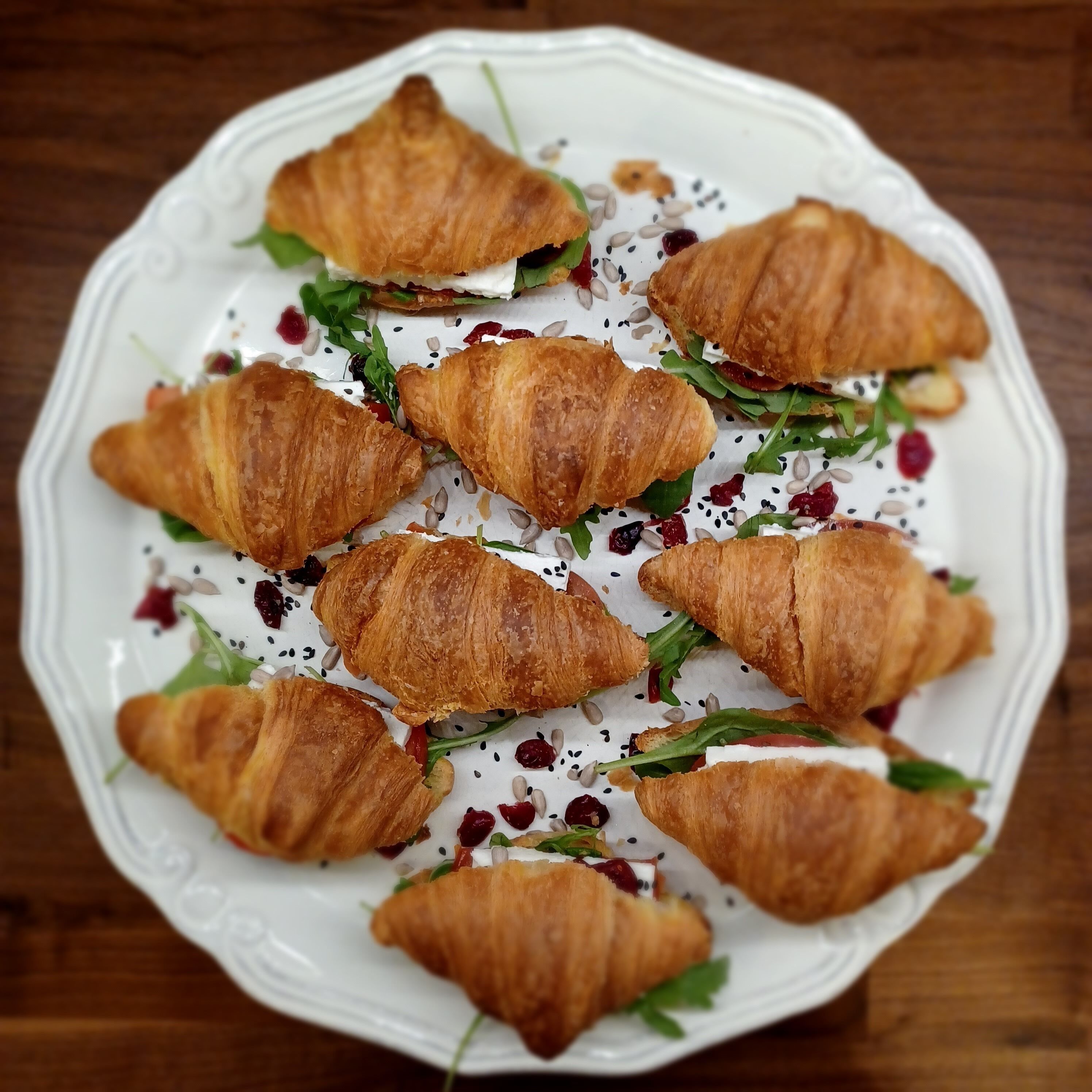A plate of croissants with cream cheese and berries.