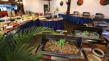 A buffet setup with various food stations, including a labeled 'Island Fried Rice' and 'Fried Noodles' section.