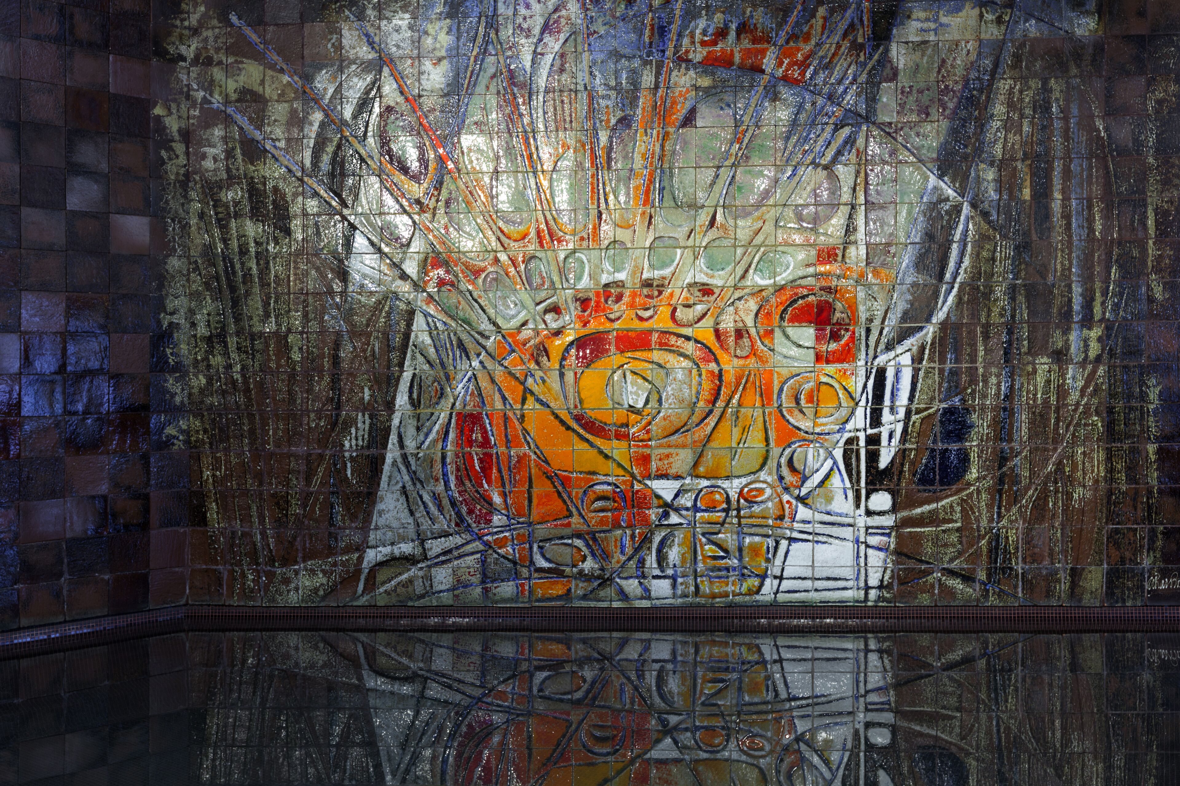 Een mozaïek met abstracte patronen en een reflecterend oppervlak eronder.