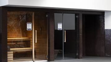 Enter a welcoming space with a bench outside the entrance, featuring a partially open door and informative signs.