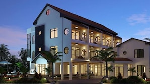 A multi-story hotel with a modern design, featuring balconies and large windows. - Herdmanston Lodge (Georgetown)