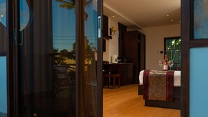 A modern interior with a wooden floor, a dining area with a table and chairs, and a kitchen area with a counter and appliances. - Herdmanston Lodge (Georgetown)