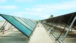 A rooftop with multiple rows of solar panels.