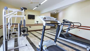 A fitness center with treadmills, a weight machine, and a stationary bike.