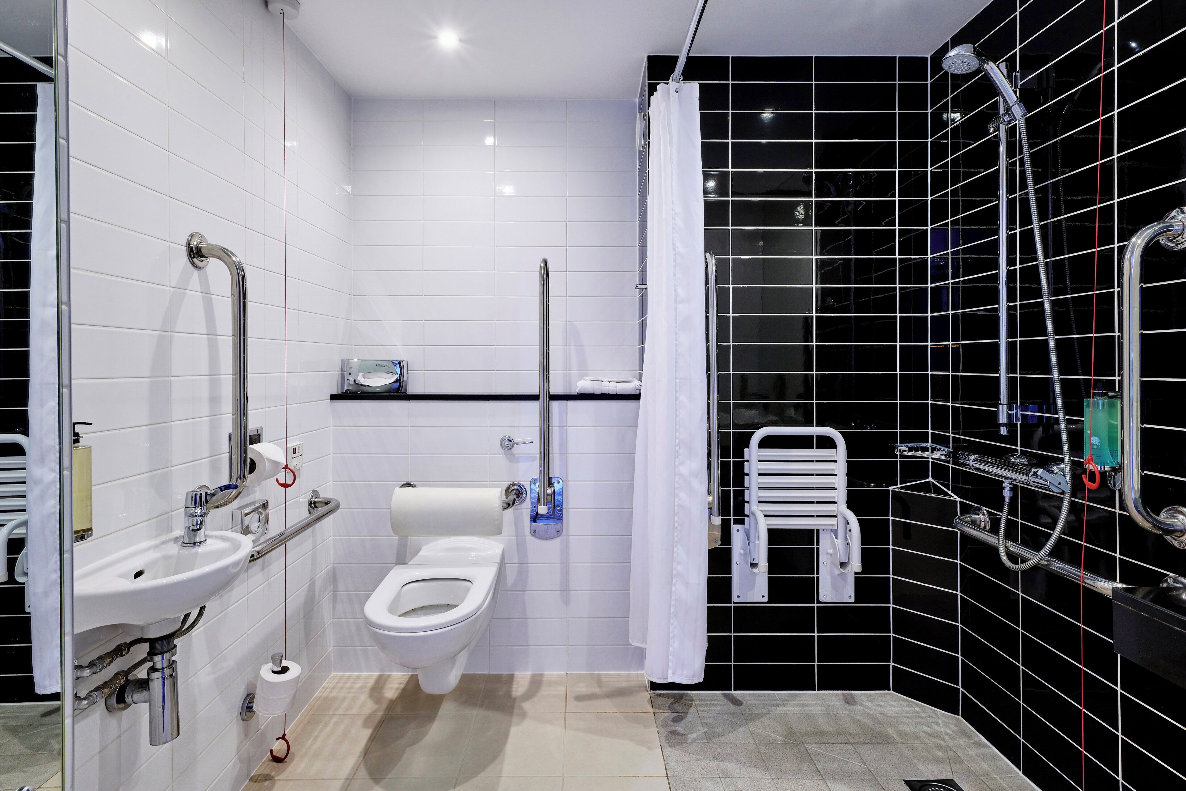 A modern bathroom with a toilet, sink, and shower.