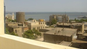 A view of a coastal cityscape with buildings and a body of water in the background. - The Horizon Hotel (Baku)