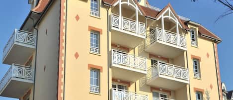 A multi-story hotel with balconies, a central dome, and a symmetrical facade.