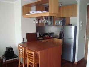 Full-sized fridge, microwave, stovetop, cookware/dishes/utensils