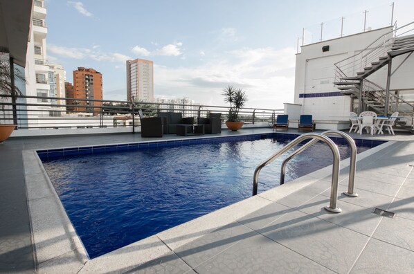 Outdoor pool, open 8:00 AM to 11:00 PM, pool umbrellas