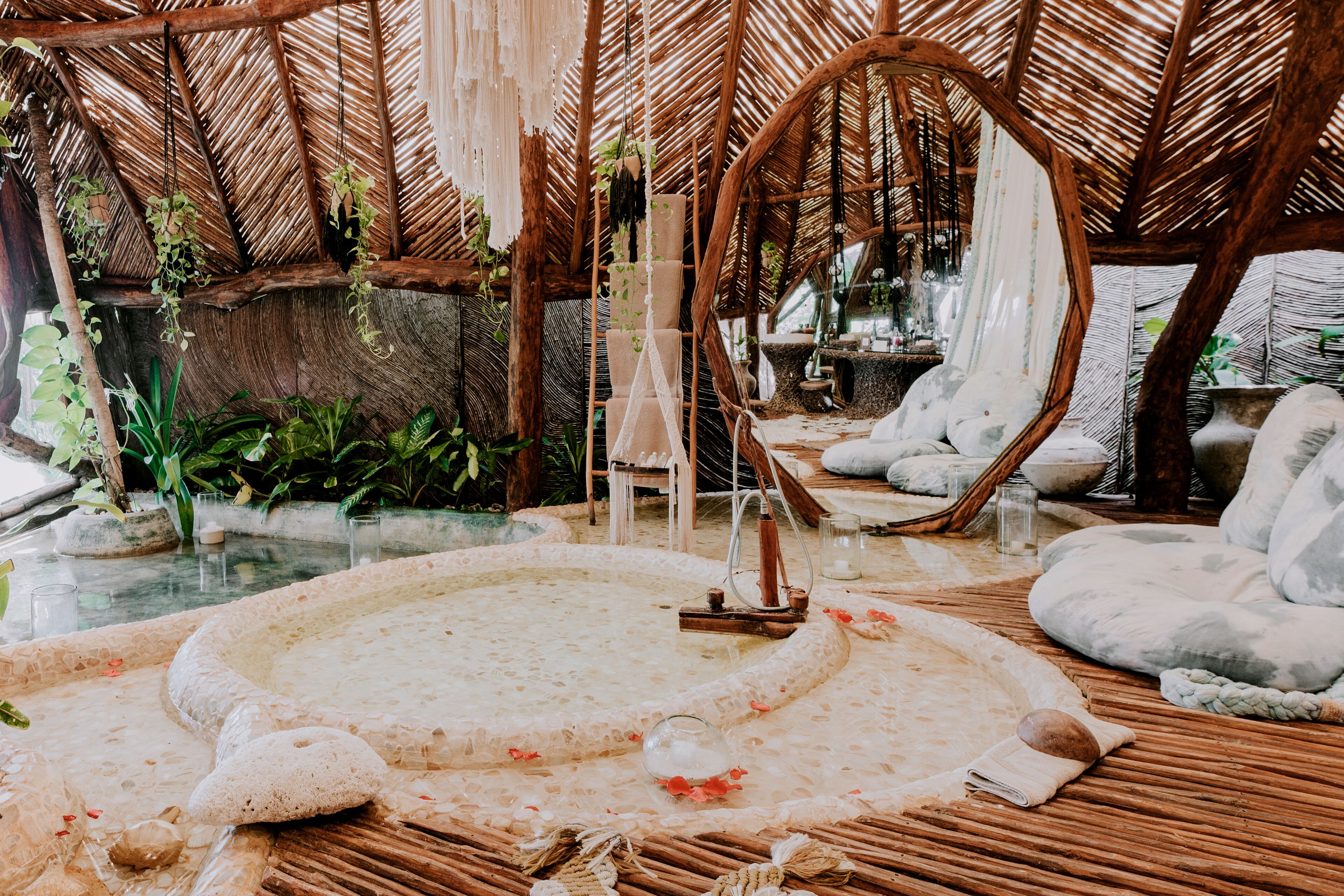 A spa area with a hot tub, seating, and plants.