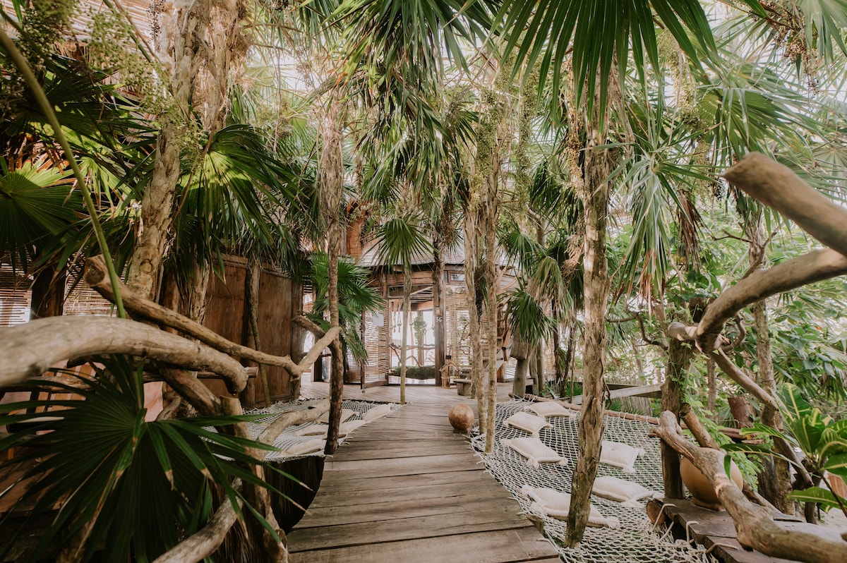 Azulik Tulum Treehouse Eco Resort round bed with canopy and shell-shaped bathtub