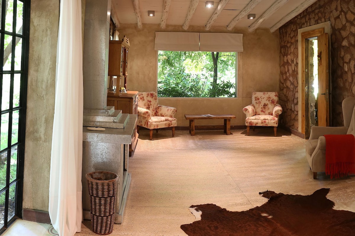 Ein Schlafzimmer mit einem großen Bett, einem Nachttisch aus Holz, einem Schreibtisch und einem Stuhl.