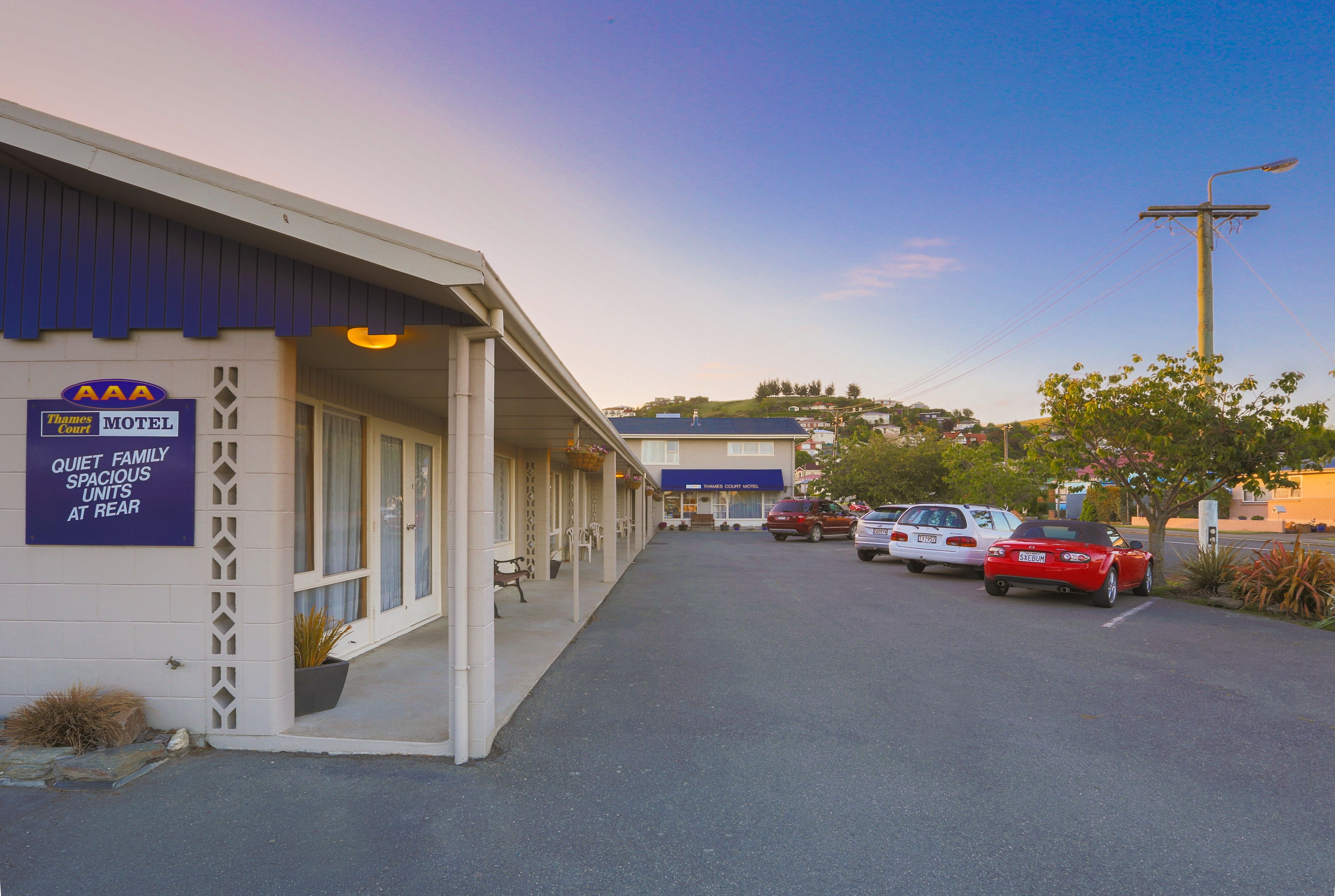 A motel with a sign indicating quiet family spacious units at rear.