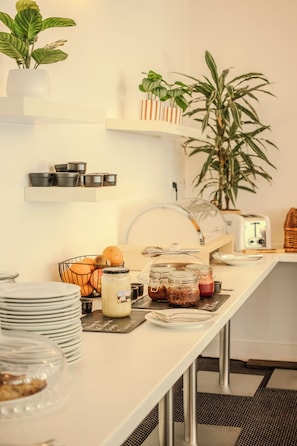 A kitchen with a white countertop, a sink, a toaster, and various food items. - Le Manoir De Sauvegrain (Saint-Lambert)