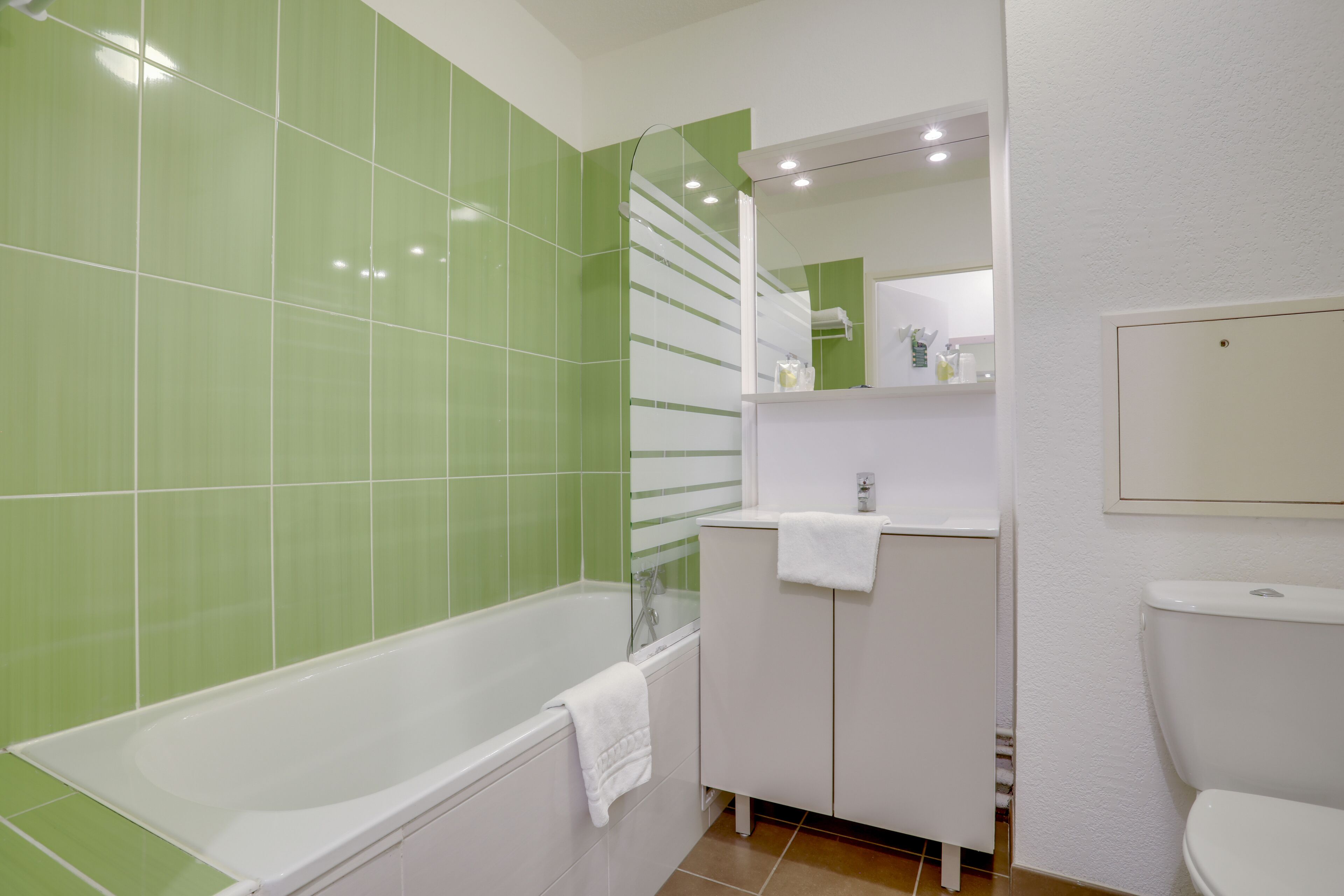 A bathroom with a bathtub, a sink, and a toilet.