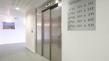 An elevator with a sign indicating floors 101 to 511.