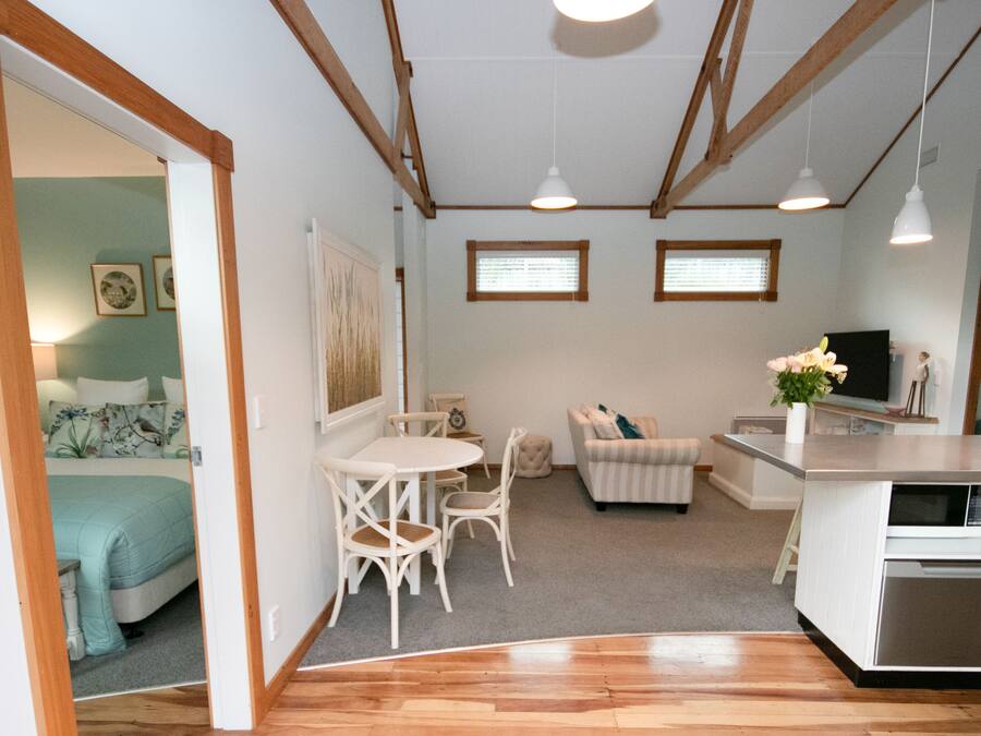 Um espaço compacto para viver, com cozinha compacta, área de refeições e quarto.