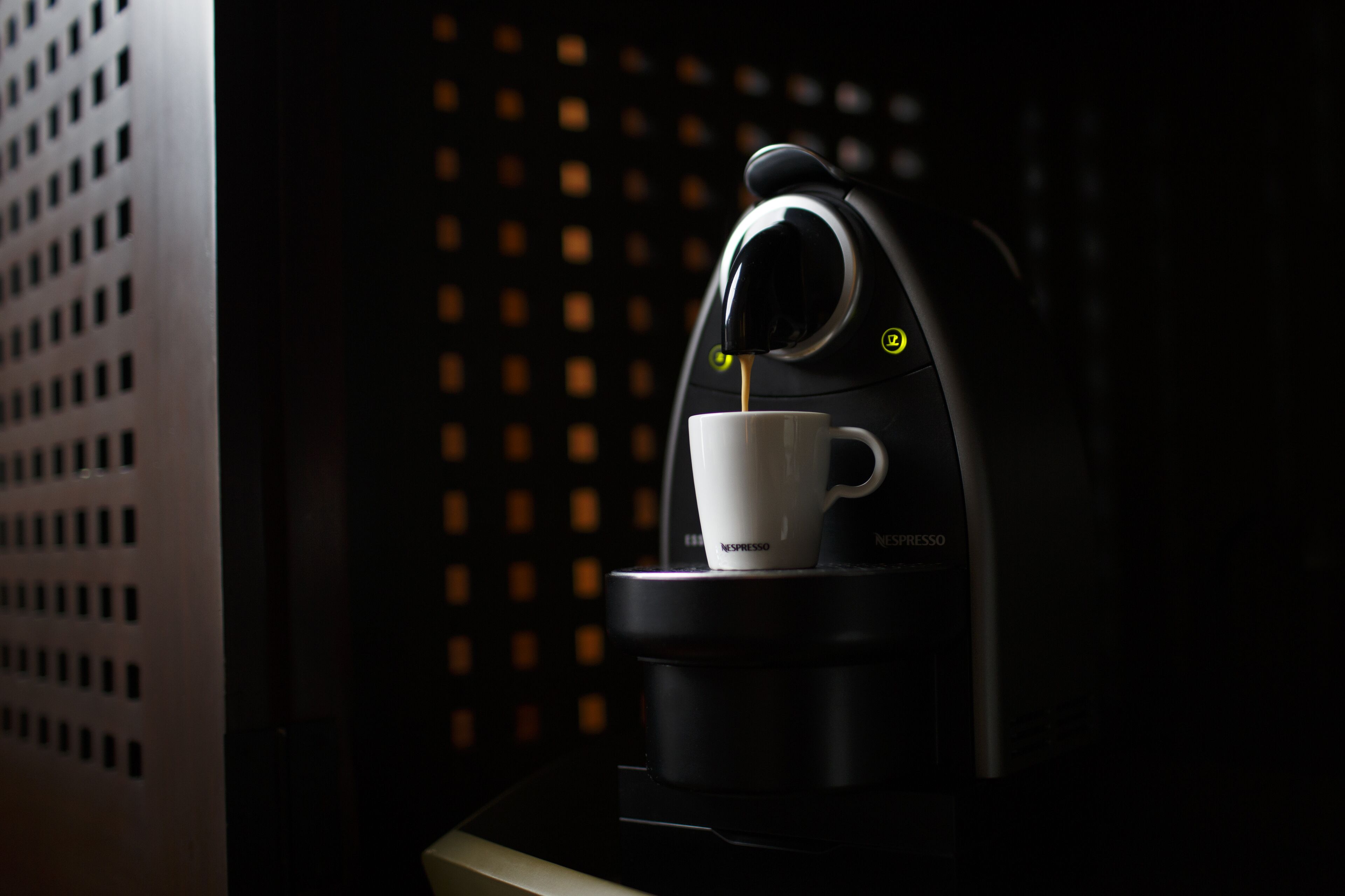 A coffee machine with a cup of coffee.
