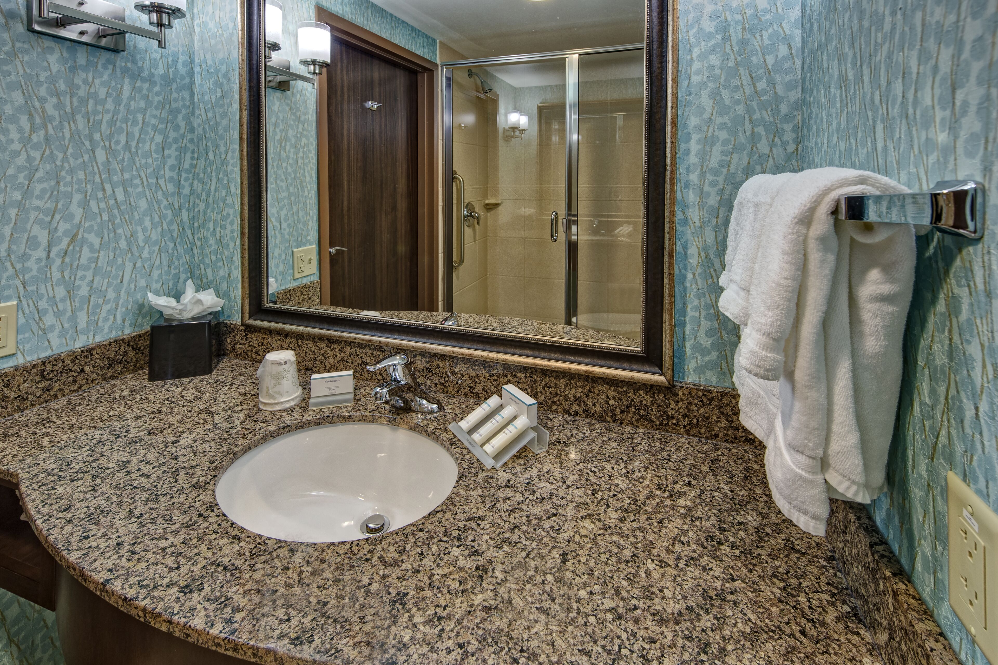 designer toiletries, hair dryer, towels, soap