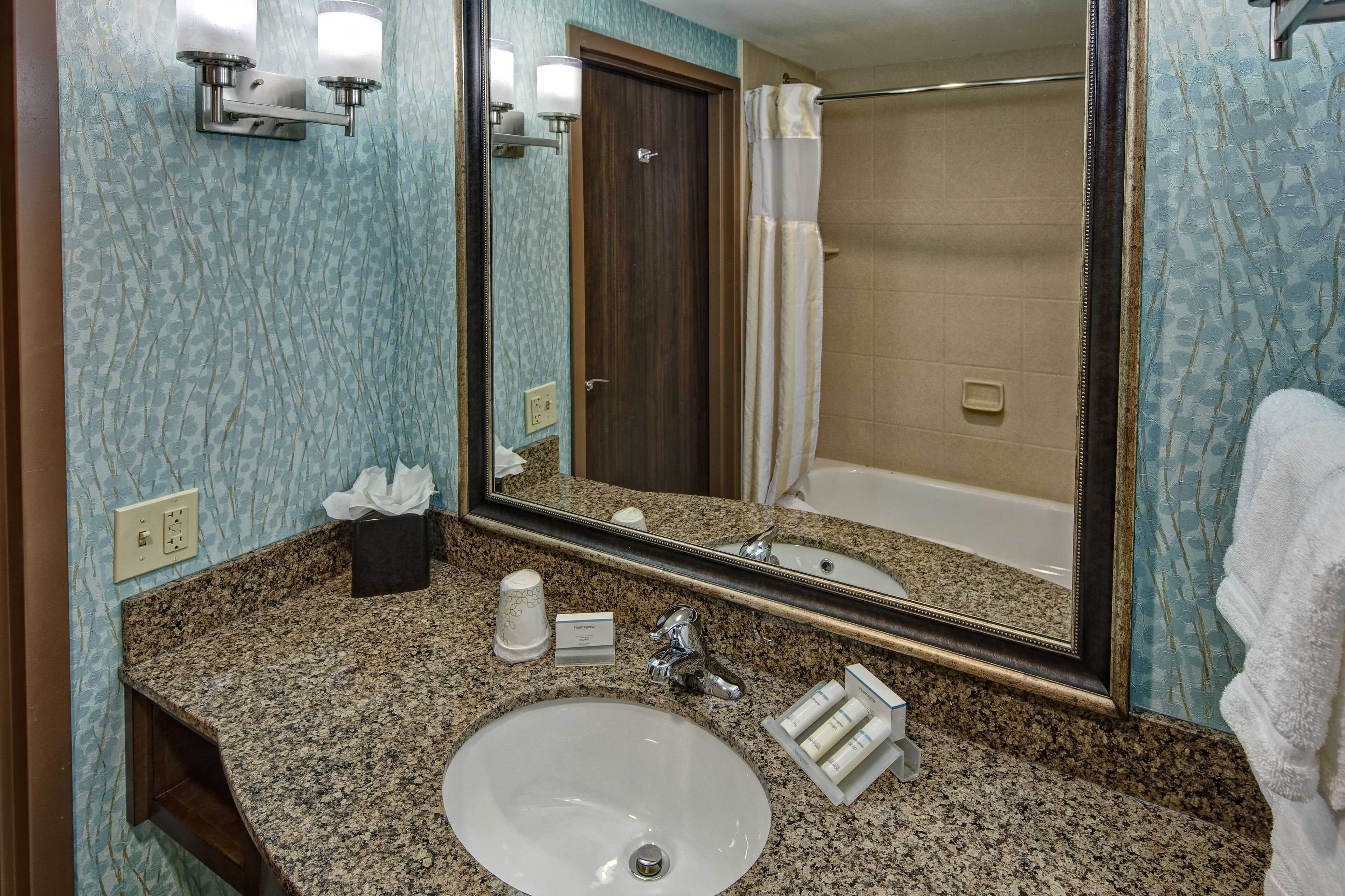 designer toiletries, hair dryer, towels, soap