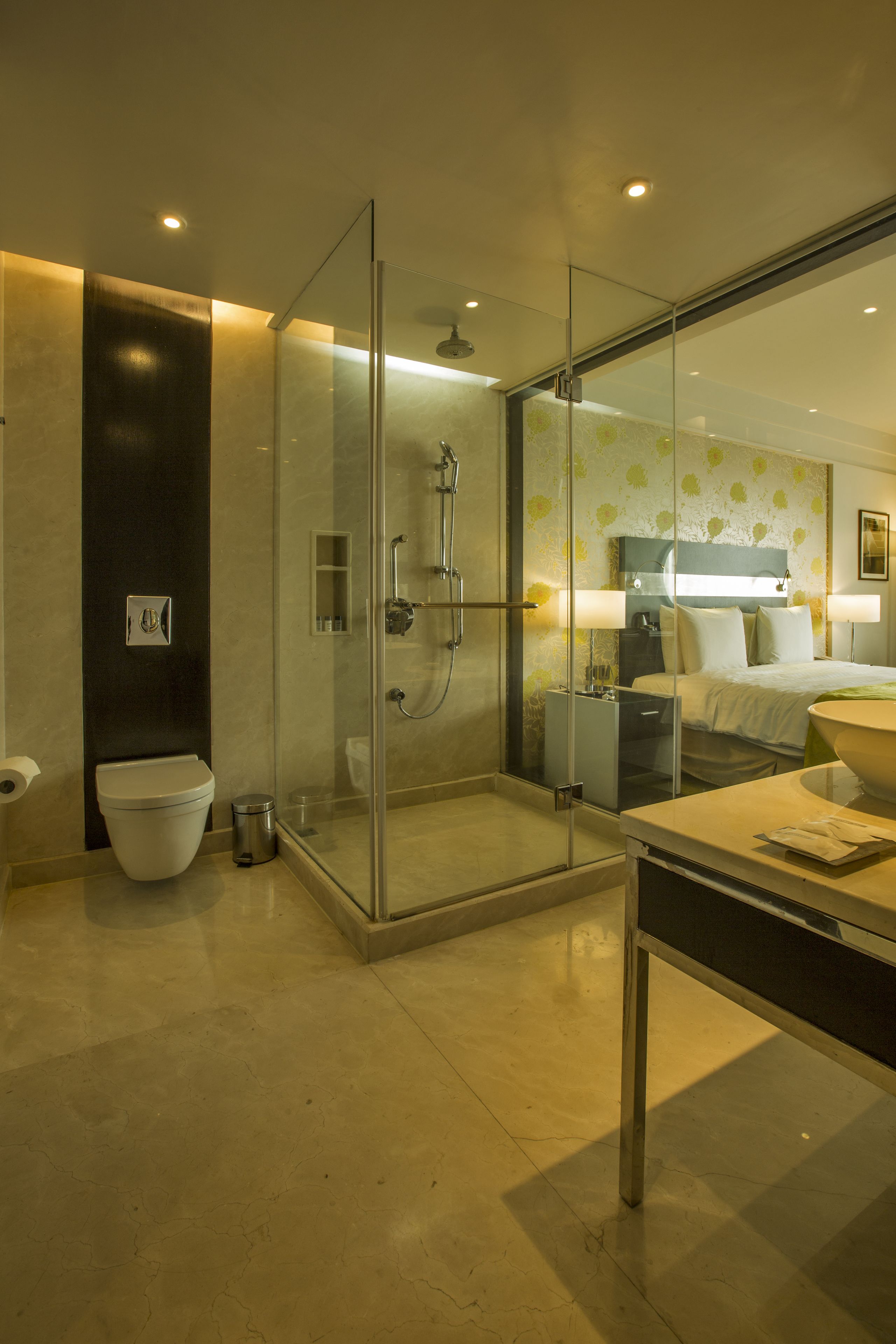A modern bathroom with a glass-enclosed shower, a toilet, and a vanity with a sink.